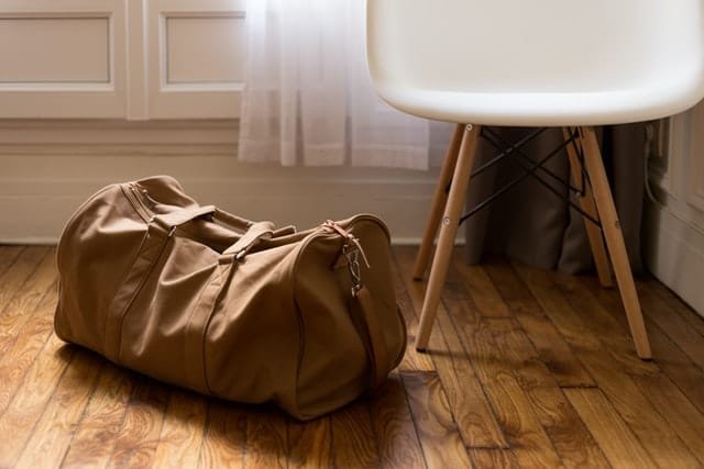 A big brown travel bag on the floor