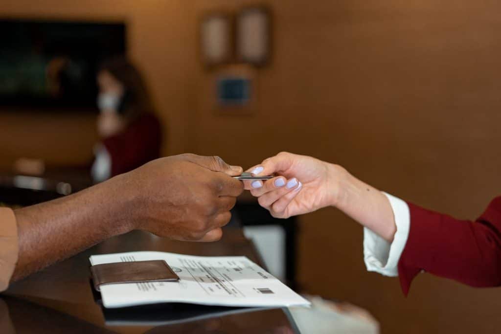 A guest collecting a Hotel card from the receptionist