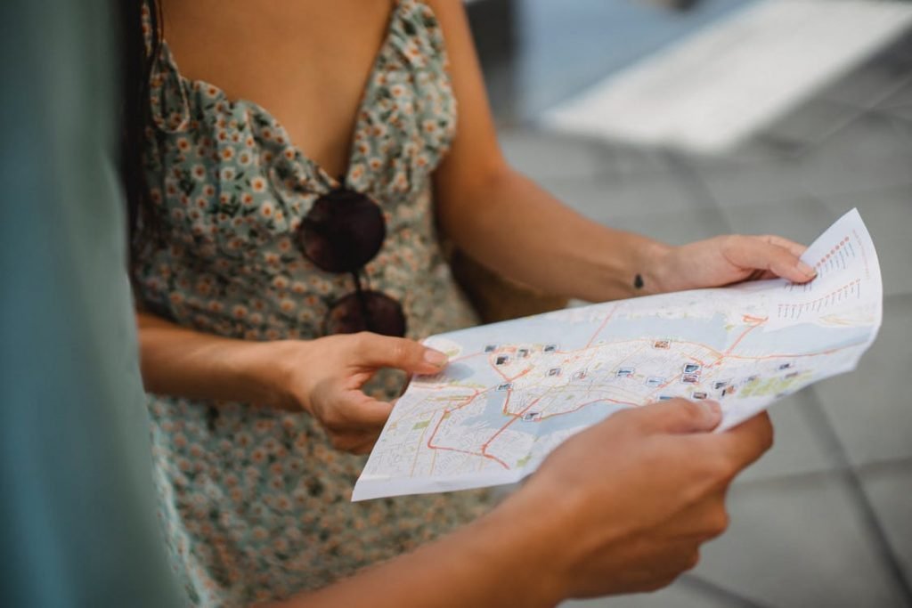 A couple choosing their destination together via a map in their hands