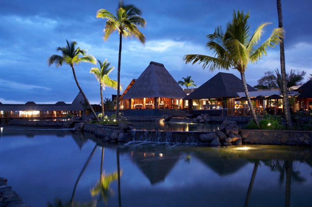 Four Seasons Resort, AnahitaNight scene at a beach in Mauritius with the huts shining brightly