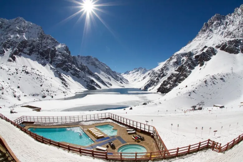 Best Skiing Resorts In The World

A large skiing resort with snow peaked mountains and a pool in the middle