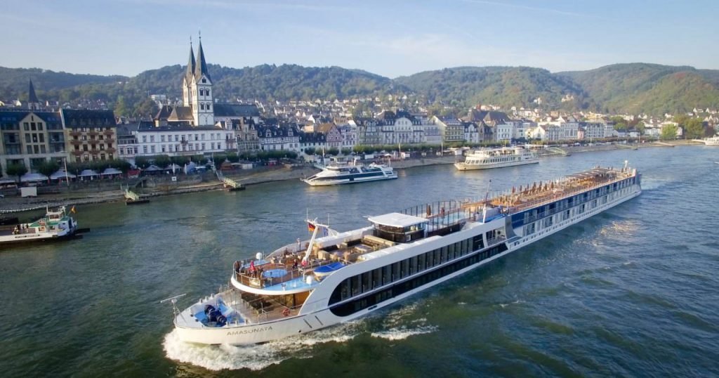 A long cruise ship with tourists, on the Rhine River