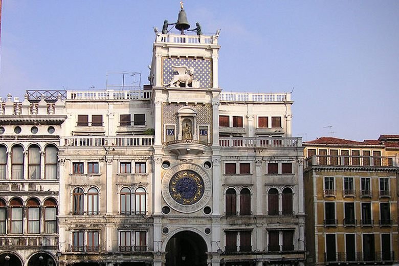 white large building with a bell at the top