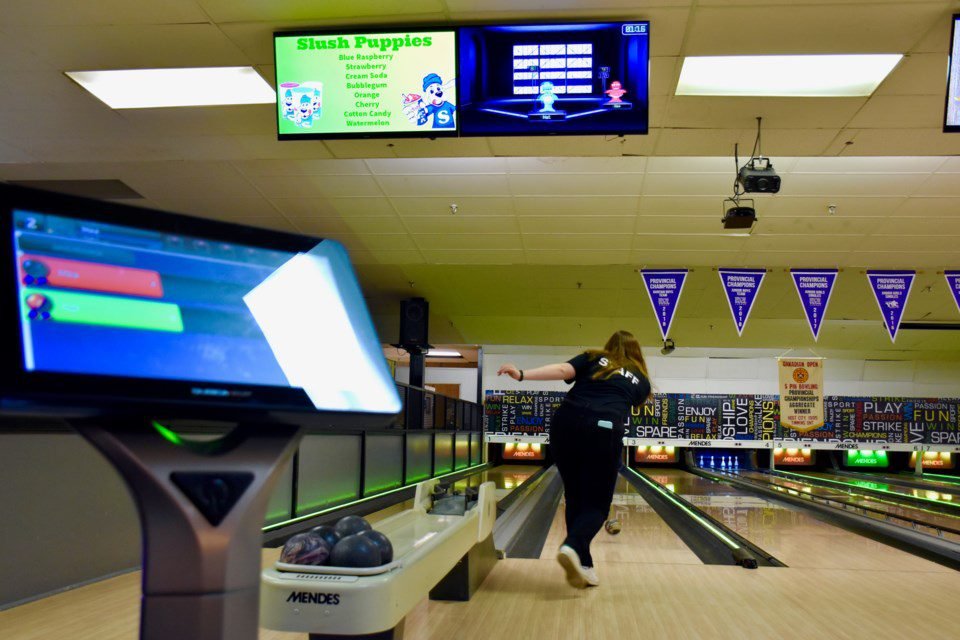 a woman bowling in tourist spots in Timmins, Canada