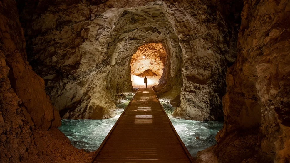 a person in the middle of a cave in top attraction 