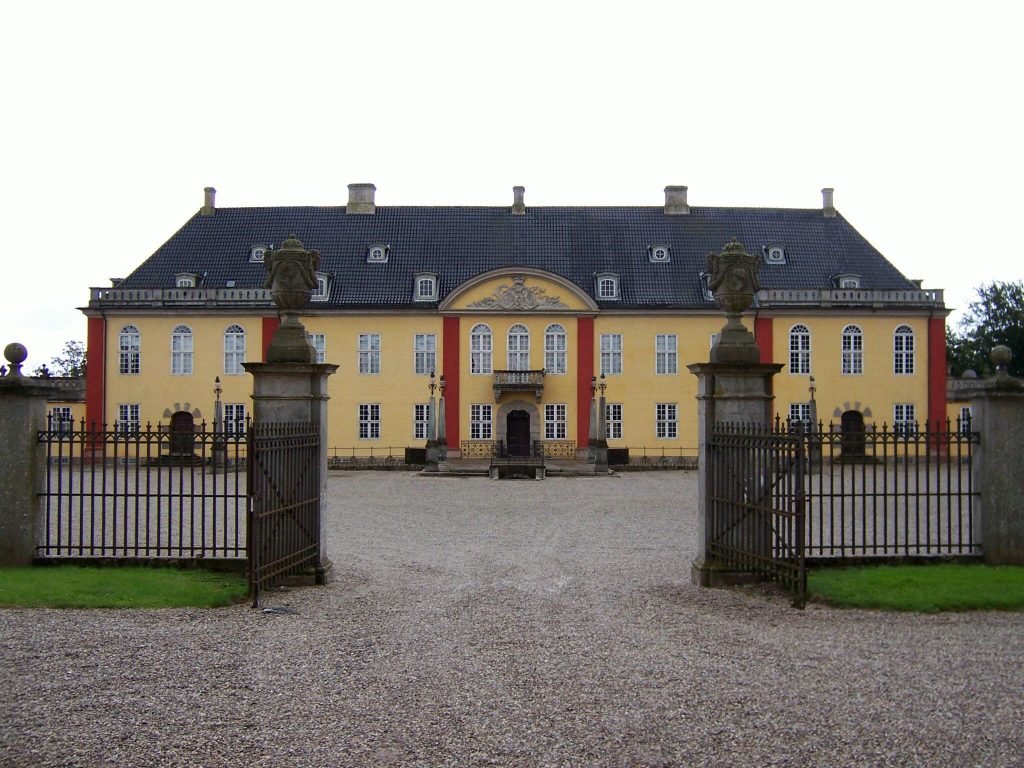 gates opened to a yellow palace in top-rated attractions in Roskilde, Denmark