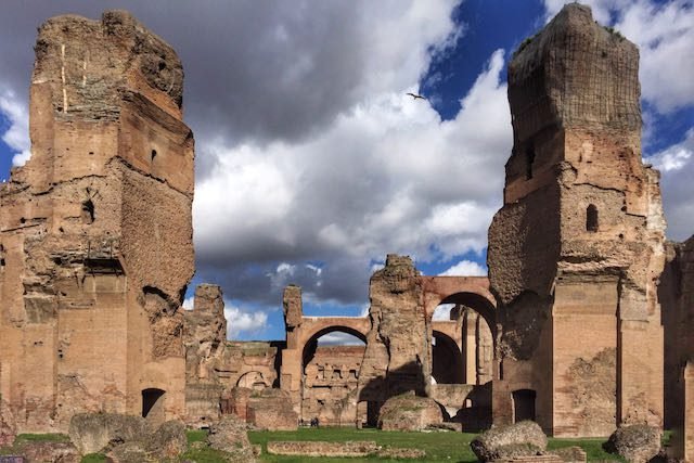 brown old structures under a blue and white sky