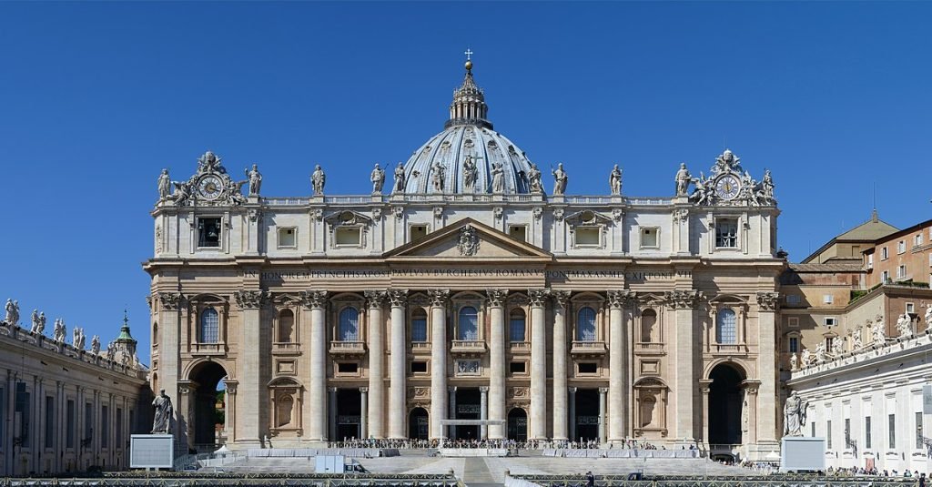 white building of a church under a blue sky in places in Perugia, Italy. 