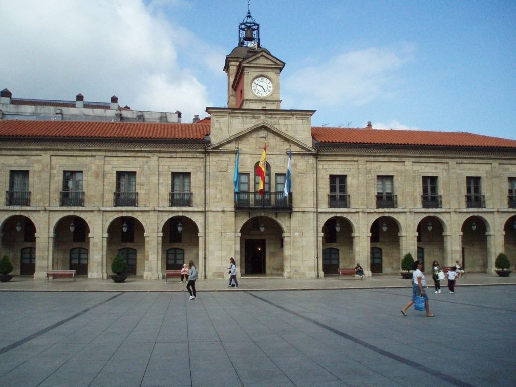 a building with a clock in daytime in top things to do in Avilés, Spain