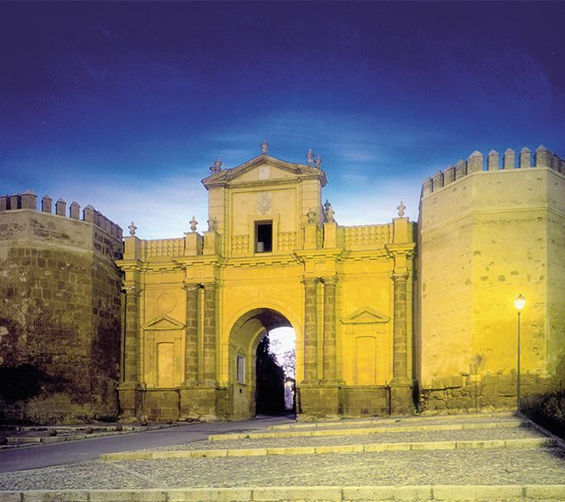 yellow building under a blue sky in amazing places to visit in Carmona, Spain