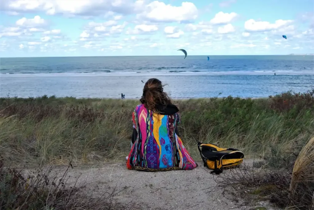 A lone female solo traveler starring at the sea