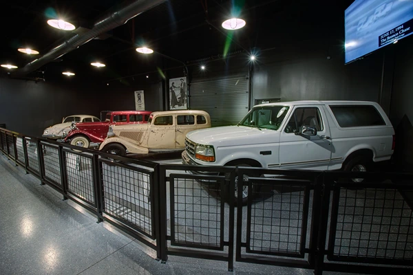 Four cars in a showroom under bright lights