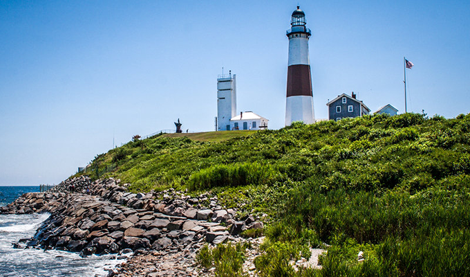 Places to Visit On Long Island, New York

A white-painted lighthouse beside a lake with stones covered with green shrubs