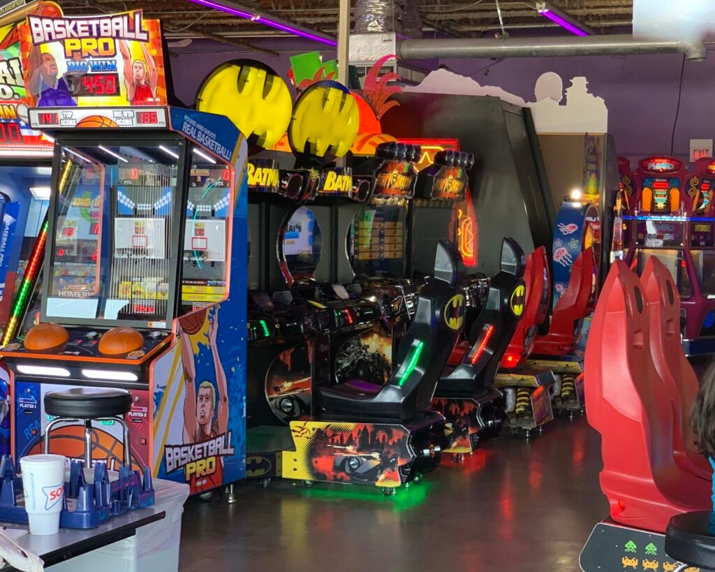 A large arcade room with lots of arcade game machines